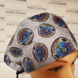 May include: Gray scrub hat with a repeating pattern of colorful Grateful Dead "Steal Your Face" logos.