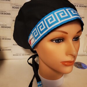 May include: Black surgical scrub hat with a blue and white geometric patterned band. The hat has a tie at the back.