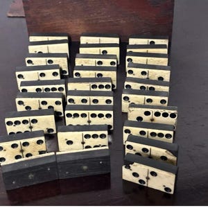 Handsome set of late Victorian dominoes contained within their stained wooden storage box with a sliding lid