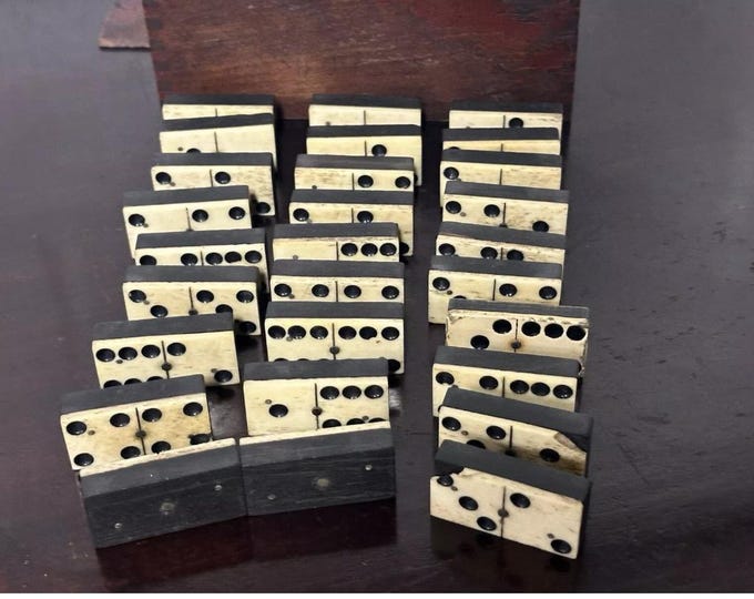 Handsome set of late Victorian dominoes contained within their stained wooden storage box with a sliding lid