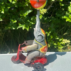 Rare Original Vintage Circa 1940’s Tinplate Mechanical Wind Up Elephant On Scooter balancing a ball