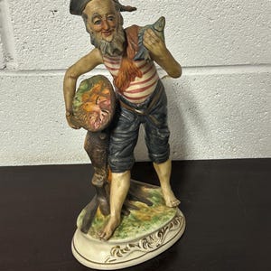 Lovely Circa 1960’s Vintage Italian Ceramic Capodimonte Figurine Of A Fisherman Holding a Fish