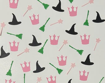 May include: Pink and black paper cutouts of crowns, witches' hats, brooms, and wands. These cutouts are perfect for party decorations or scrapbooking.
