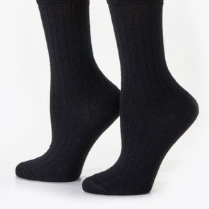 May include: A pair of black ribbed socks. The socks are made of a soft, comfortable material and are perfect for everyday wear.