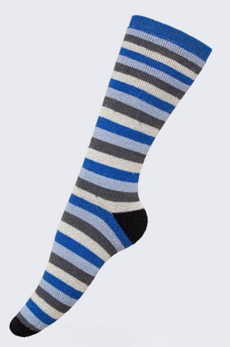 May include: A knee-high sock with horizontal stripes in shades of blue, gray, and white. The heel and toe are black. The sock is made of a soft, knitted material.