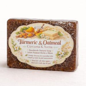 May include: A rectangular bar of handmade soap with a label that reads "Turmeric & Oatmeal". The label features illustrations of turmeric, honey, and oats. The soap is a dark brown color and is wrapped in clear plastic.