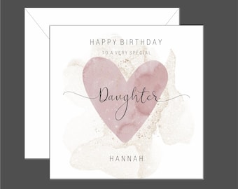 May include: A white card with a pink watercolor heart and gold glitter. The text "Happy Birthday to a very special Daughter Hannah" is printed on the card.