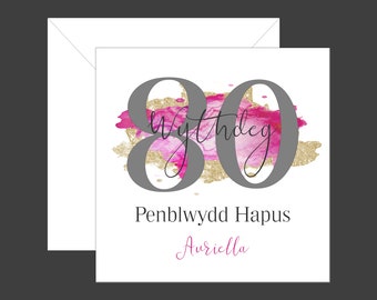 May include: A pink and gold watercolor birthday card with the number 80 and the text "80th Birthday" and "Penblwydd Hapus Aureilla".