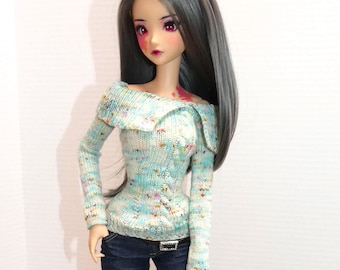 May include: A doll with long black hair wearing a light blue and white patterned sweater, blue jeans, and white sneakers.