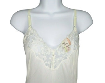 May include: White lace slip with adjustable straps and a V-neckline. The slip has a delicate floral lace pattern and a tag that reads "Maya  Fashions".