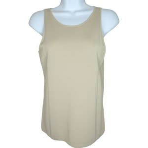 May include: A beige sleeveless ribbed knit tank top.