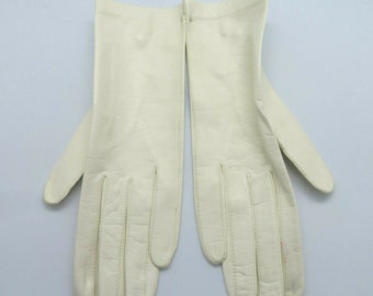 May include: A pair of white leather gloves. The gloves are made of a smooth, supple leather and have a classic design.