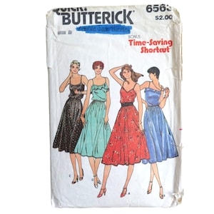 May include: A vintage sewing pattern for four different dresses. The pattern is from Butterick and is number 6563. The dresses are all sleeveless and have a variety of floral prints. The pattern includes a bonus time-saving shortcut.