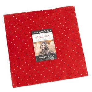 May include: A square of red fabric with white polka dots. A label on the fabric reads "Moda Magic Dot" and features a woman's image. The fabric is likely for quilting or other craft projects.