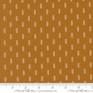 May include: A fabric with a repeating pattern of small white ovals on a mustard yellow background. The fabric is woven with a subtle texture.