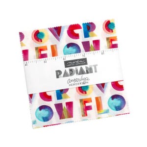 May include: A bundle of fabric squares with a white background and colorful text that reads "OVER FLOW". The fabric is wrapped with a white label that reads "RADIANT" and "amarilys henderson".