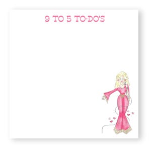 May include: A square white notepad with the text 9 TO 5 TO-DO'S printed in pink at the top. The bottom right corner features a colorful illustration of a blonde figure wearing a pink jumpsuit with fringe, holding a microphone, surrounded by stars.