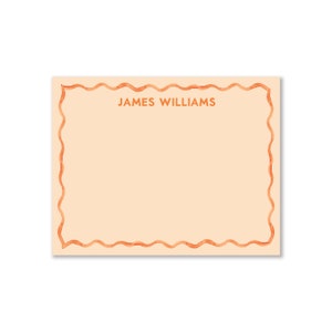 May include: A peach-colored stationery card with a wavy orange border. The name "JAMES WILLIAMS" is printed in orange at the top of the card.