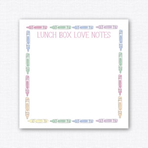 May include: A white card with a pink border and the text "Lunch Box Love Notes" in pink. The border is made of a repeating pattern of colorful crayons.