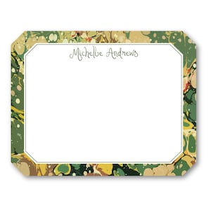 May include: A rectangular stationery card with a white interior and a decorative border. The border features a marbled design in shades of green, yellow, and brown. The name "Michelle Andrews" is written in green script within the white space.