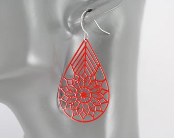 May include: Red teardrop-shaped earrings with a delicate, intricate laser-cut design. The earrings feature a floral pattern with a geometric center.