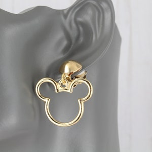 May include: Gold-tone clip-on earrings featuring a Mickey Mouse head design.