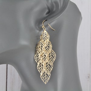 Gold chandelier earrings filigree leaf leaves earrings dangle cut out pattern lightweight 2 7/8&quot; long shiny gold leaves
