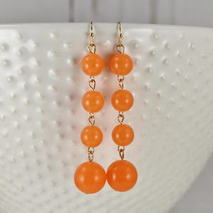 Orange beaded chandelier Earrings lightweight Dangle 2 7/8&quot; long skinny Gold beaded wiggly flowy dangly earrings