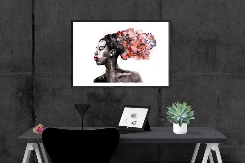 May include: A black and white watercolor painting of a person with a red and pink floral design in their hair. The painting is framed and hanging on a gray wall.