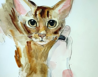 May include: Watercolor painting of a cat with brown and tan fur, large eyes, and pink-lined ears. The cat is being held by a hand with a black ring. The artwork is signed "Adamson 25".