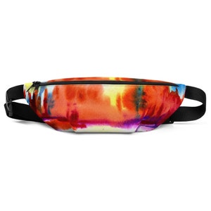 May include: A colourful fanny pack with a tie-dye pattern in shades of orange, yellow, blue, and purple. The pack has a black adjustable strap.