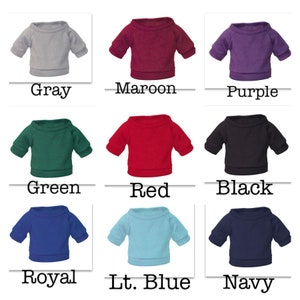 May include: Nine different color crew neck sweatshirts. The colors are gray, maroon, purple, green, red, black, royal blue, light blue, and navy.