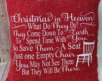 May include: Red throw pillow with white text that reads "Christmas in Heaven What Do They Do? They Come Down To Earth To Spend Time With You. So Save Them A Seat Just One Empty Chair. You May Not See Them But They Will Be There."  The pillow has a white embroidered image of a chair.