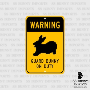 May include: A yellow warning sign with black text and a black silhouette of a rabbit. The sign reads "WARNING GUARD BUNNY ON DUTY".