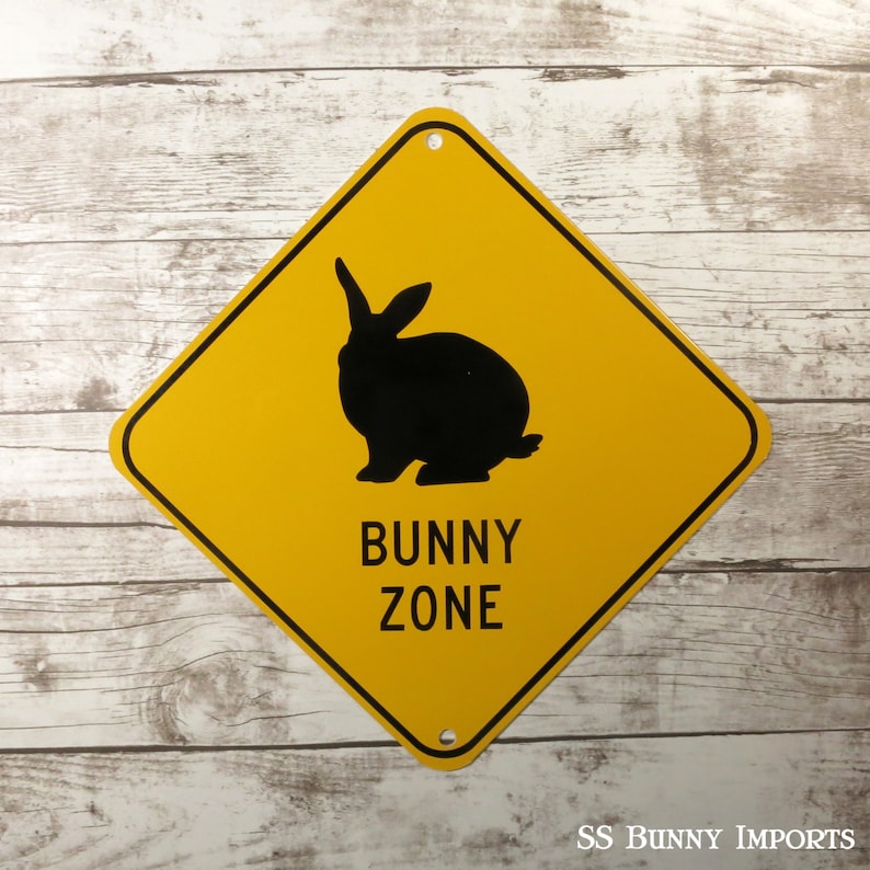 May include: Yellow diamond-shaped sign with a black silhouette of a rabbit and the text "BUNNY ZONE".