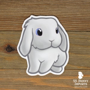 May include: A white cartoon bunny rabbit with blue eyes and floppy ears. The bunny is standing on all fours and has a fluffy tail.