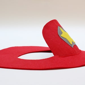 May include: Red felt firefighter hat with a gray and yellow star badge.