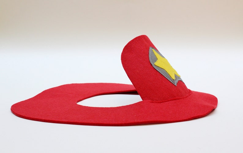 May include: Red felt firefighter hat with a gray and yellow star badge.