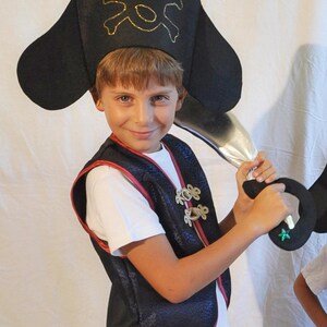 Ragazzino con i suoi costumi da pirata per vestire i giochi di bambole