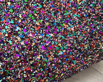 May include: A sheet of colorful glitter with a variety of shapes and sizes. The glitter is a mix of red, orange, yellow, green, blue, purple, and black.