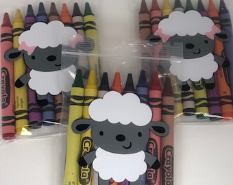 May include: Two clear plastic bags filled with Crayola crayons and a white sheep with a gray face and pink bow. The bags are tied with a twist tie.