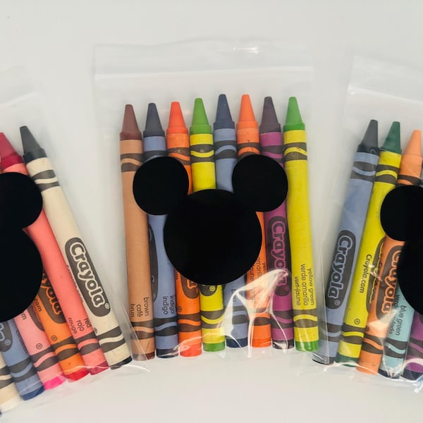 May include: Three clear plastic bags each filled with a set of Crayola crayons. Each bag has a black Mickey Mouse head shape attached. The crayons are various colors, including red, pink, blue, and yellow.