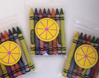 May include: Three clear plastic bags filled with Crayola crayons. Each bag has a yellow lemon slice sticker with a pink center.