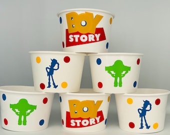 May include: Six white paper cups with colorful polka dots and Toy Story characters. The cups have the words "Toy Story" printed on them in red and yellow letters.