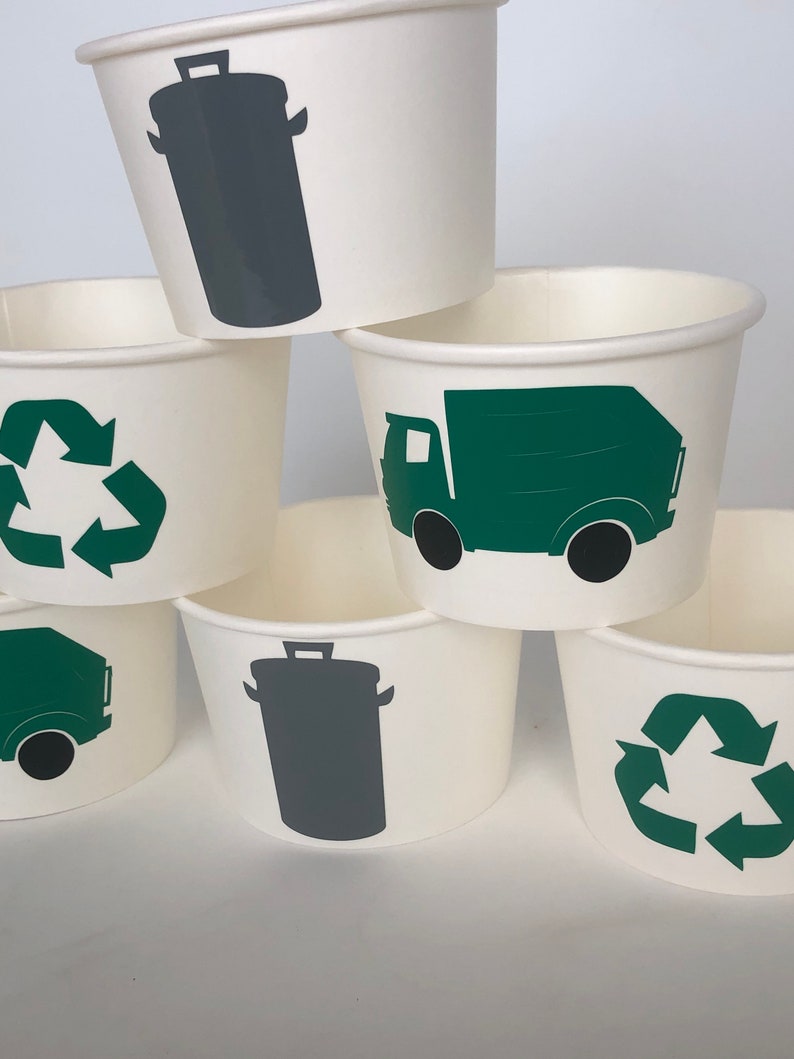 May include: Set of six white paper cups with green and gray recycling themed designs. The designs include a recycling symbol, a garbage truck, and a trash can.