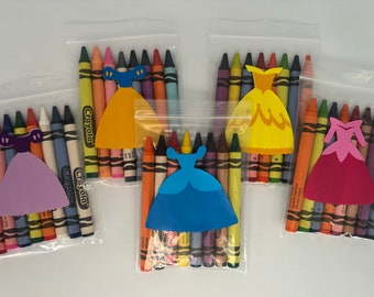 May include: Four clear plastic bags each containing a set of crayons and a paper cutout of a princess dress. The dresses are purple, yellow, blue, and pink. The bags are labeled "Crayola".