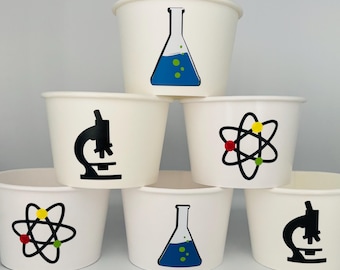May include: Six white paper cups with different science-themed designs. The designs include a beaker, a microscope, and an atom. The cups are perfect for a science-themed party.