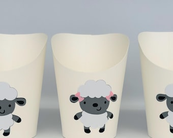 May include: Three white paper cups with a black and white sheep design. The sheep has pink bows on its ears.