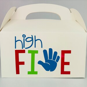 May include: White cardboard party favor box with a blue handprint and the text "high FIVE" in red, green, and blue letters.