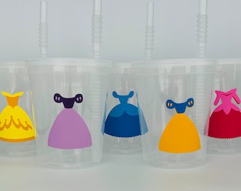 May include: Set of six clear plastic cups with straws, each decorated with a different princess dress design. The dresses are yellow, purple, blue, yellow, and pink.